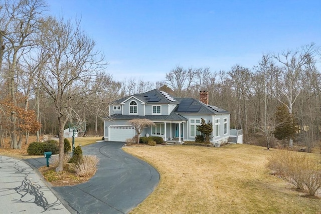 33 Gulf Hill Dr, Dartmouth, MA 02748 - traditional-style home featuring solar panels, a chimney, covered porch, a front yard, and aphalt driveway