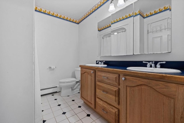33 Gulf Hill Dr, Dartmouth, MA 02748 - full bathroom with tile patterned floors, a sink, double vanity, toilet, and a baseboard radiator