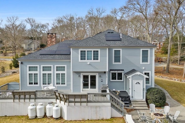 33 Gulf Hill Dr, Dartmouth, MA 02748 - back of house featuring a fire pit, solar panels, and a deck