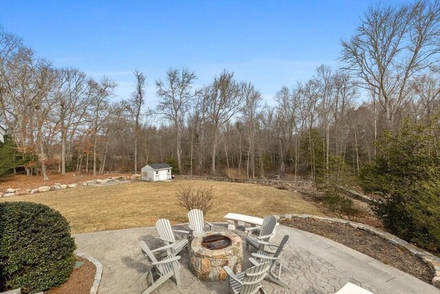 33 Gulf Hill Dr, Dartmouth, MA 02748 - view of yard with a view of trees, an outdoor structure, a patio, an outdoor fire pit, and a storage unit