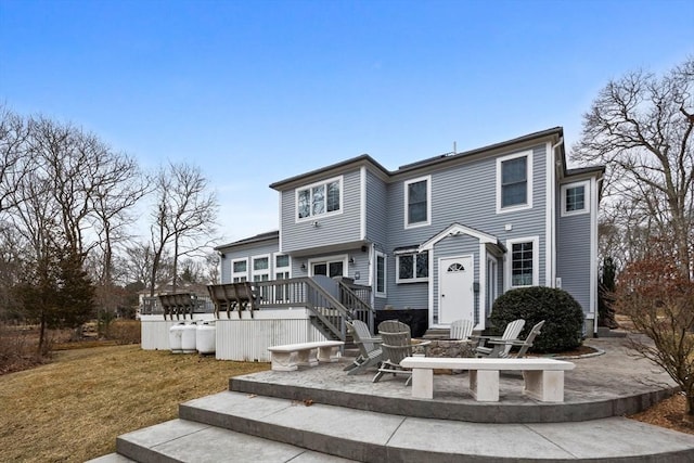 33 Gulf Hill Dr, Dartmouth, MA 02748 - back of house featuring stairway, a patio area, a wooden deck, a lawn, and an outdoor fire pit