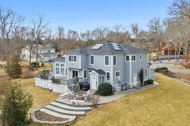 33 Gulf Hill Dr, Dartmouth, MA 02748 - back of property featuring central air condition unit, a chimney, a lawn, a fire pit, and a wooden deck