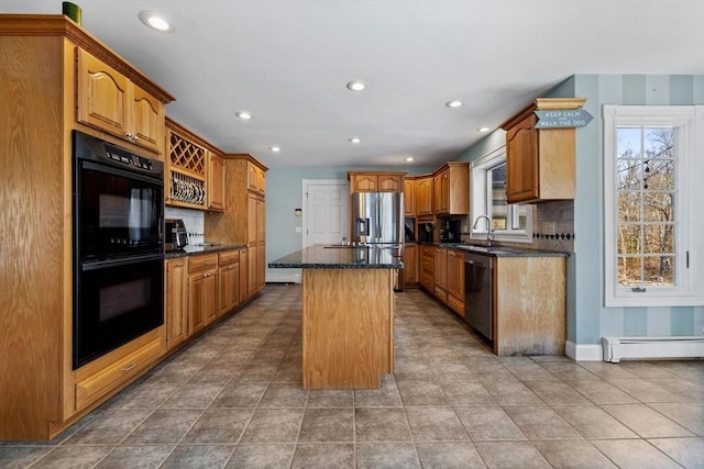 33 Gulf Hill Dr, Dartmouth, MA 02748 - kitchen with stainless steel appliances, backsplash, a sink, a kitchen island, and a baseboard radiator
