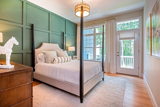 bedroom featuring light hardwood / wood-style floors and access to exterior