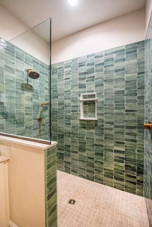 bathroom with a tile shower