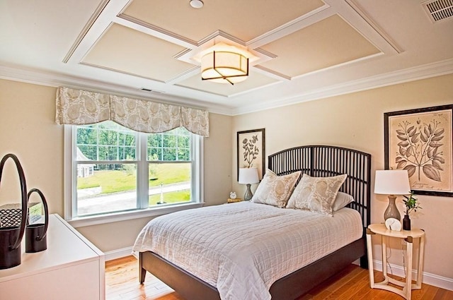 bedroom featuring hardwood / wood-style floors and crown molding