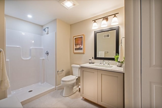 bathroom with tile patterned flooring, toilet, vanity, and walk in shower