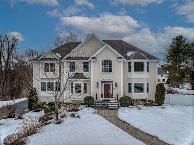 view of front of home with fence and stucco siding