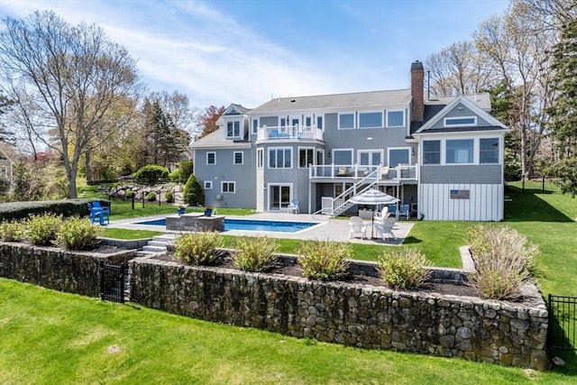 58 Williams Path, Barnstable, MA 02668 - rear view of house with a patio area, a lawn, a balcony, an outdoor pool, and a chimney