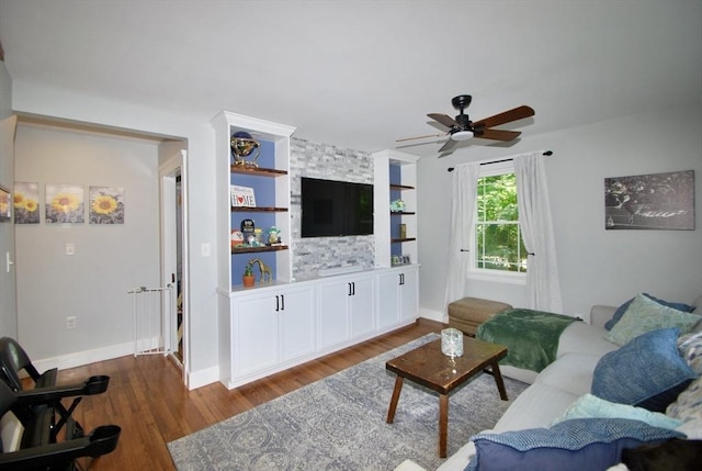 551 Indian Head St, Hanson, MA 02341 - living area featuring wood finished floors, ceiling fan, and built in shelves