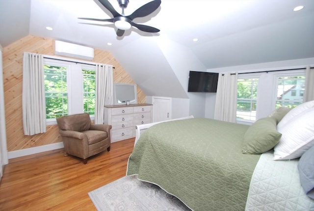 551 Indian Head St, Hanson, MA 02341 - bedroom featuring vaulted ceiling, wood finished floors, a wall unit AC, wooden walls, and a ceiling fan