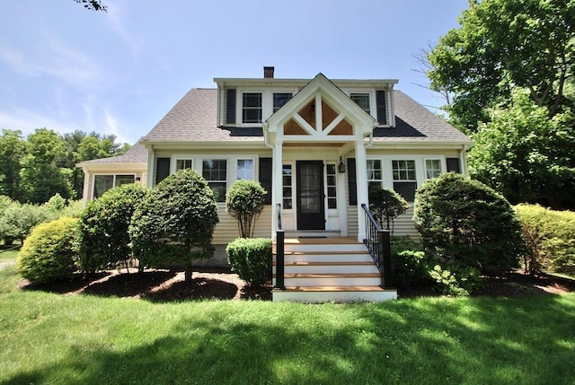 551 Indian Head St, Hanson, MA 02341 - bungalow-style house featuring a chimney, a front lawn, and roof with shingles