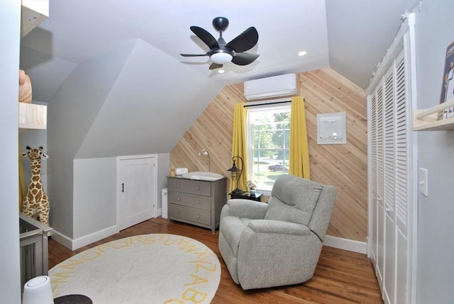551 Indian Head St, Hanson, MA 02341 - living area with an AC wall unit, wood walls, lofted ceiling, ceiling fan, and wood finished floors