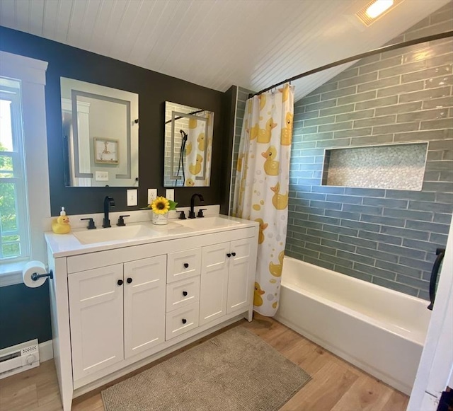 551 Indian Head St, Hanson, MA 02341 - full bathroom with wood finished floors, lofted ceiling, shower / bath combo with shower curtain, double vanity, and a baseboard heating unit