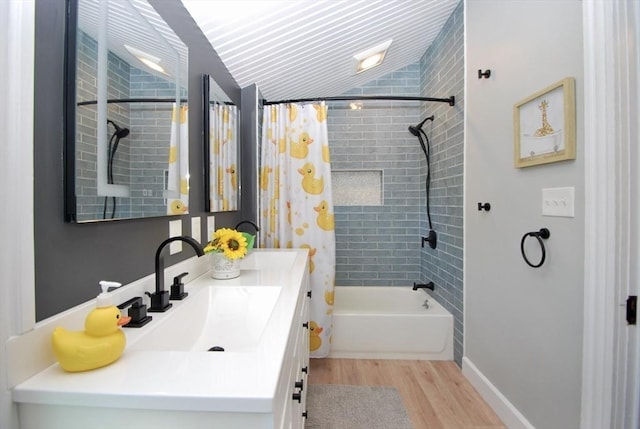 551 Indian Head St, Hanson, MA 02341 - bathroom featuring wood finished floors, vanity, shower / bath combo, and lofted ceiling
