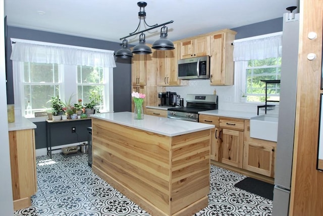 551 Indian Head St, Hanson, MA 02341 - kitchen with appliances with stainless steel finishes, light brown cabinetry, plenty of natural light, and light countertops