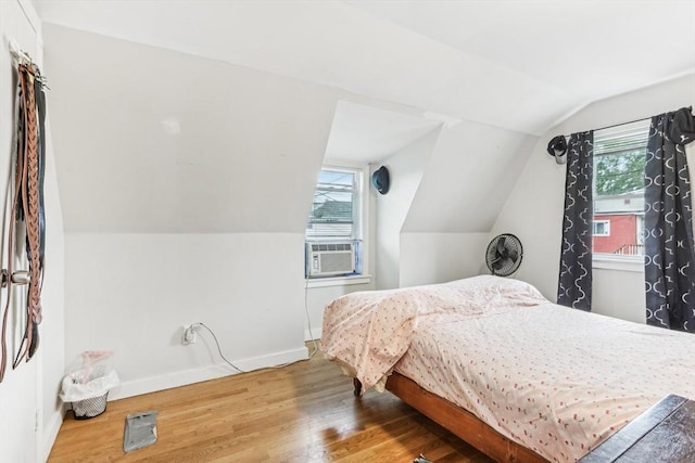 831 N Shore Rd, Revere, MA 02151 - bedroom featuring wood finished floors, vaulted ceiling, baseboards, and cooling unit