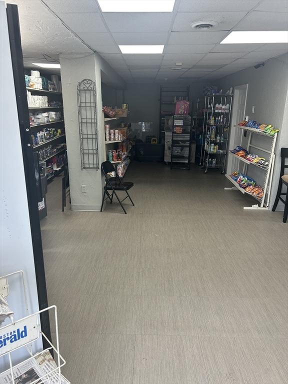 831 N Shore Rd, Revere, MA 02151 - basement featuring a drop ceiling and carpet floors