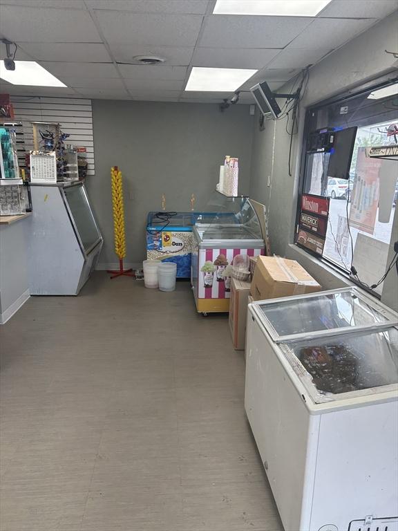 831 N Shore Rd, Revere, MA 02151 - basement featuring a drop ceiling, washer / clothes dryer, and baseboards