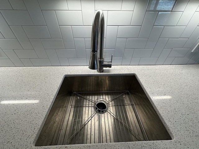 room details with light stone countertops and sink