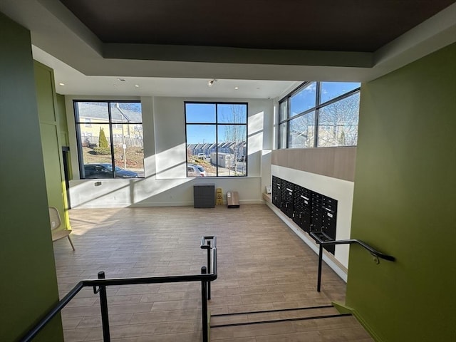 exercise room featuring mail boxes and light hardwood / wood-style flooring