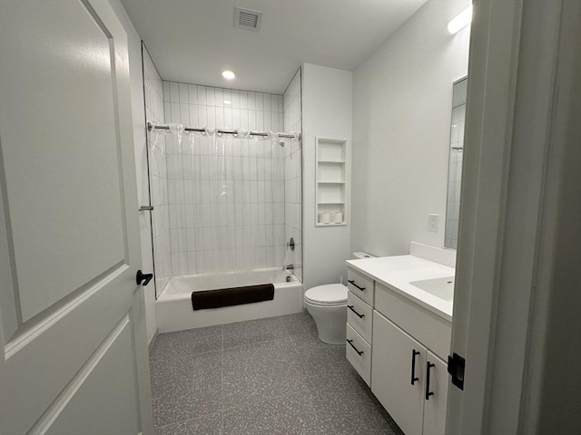 full bathroom featuring vanity, tiled shower / bath combo, and toilet