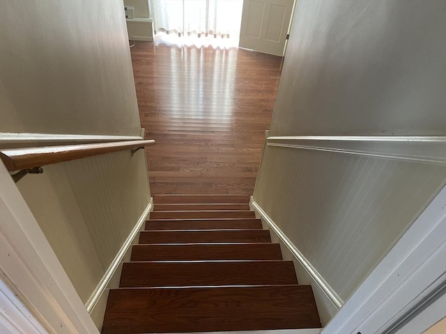 stairs featuring wood-type flooring