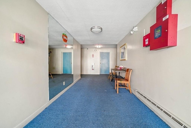 80 Main St Unit 20, Malden, MA 02148 - corridor featuring a baseboard radiator, carpet flooring, and a textured ceiling