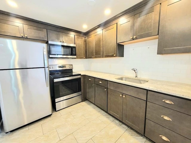 80 Main St Unit 20, Malden, MA 02148 - kitchen featuring stainless steel appliances, dark brown cabinetry, light stone countertops, decorative backsplash, and crown molding