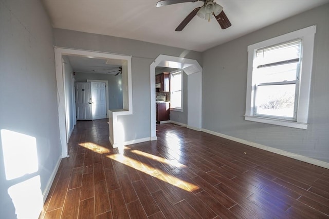 interior space featuring dark hardwood / wood-style floors, ceiling fan, and a wealth of natural light