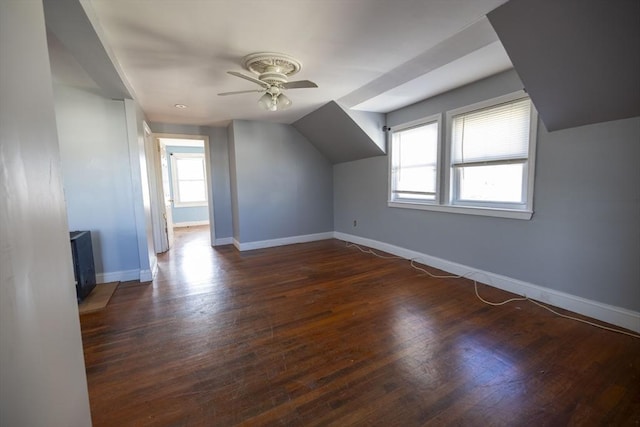 bonus room with ceiling fan, lofted ceiling, dark wood-type flooring, and a wealth of natural light