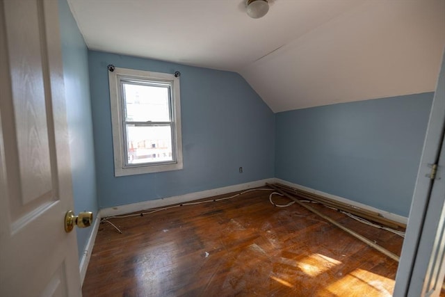 bonus room featuring dark hardwood / wood-style flooring and vaulted ceiling