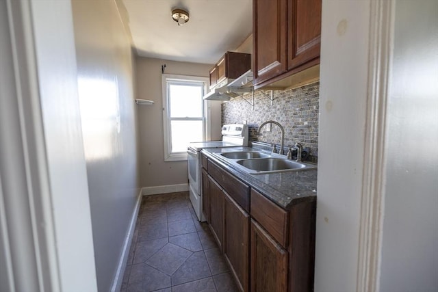 kitchen featuring tasteful backsplash, ventilation hood, sink, electric range, and dark tile patterned flooring