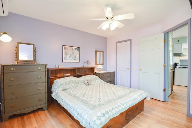 bedroom with light wood-type flooring, washer / dryer, and ceiling fan