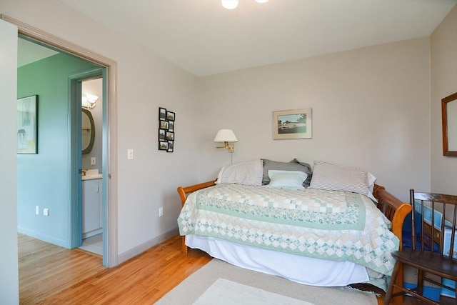 bedroom with sink and light wood-type flooring