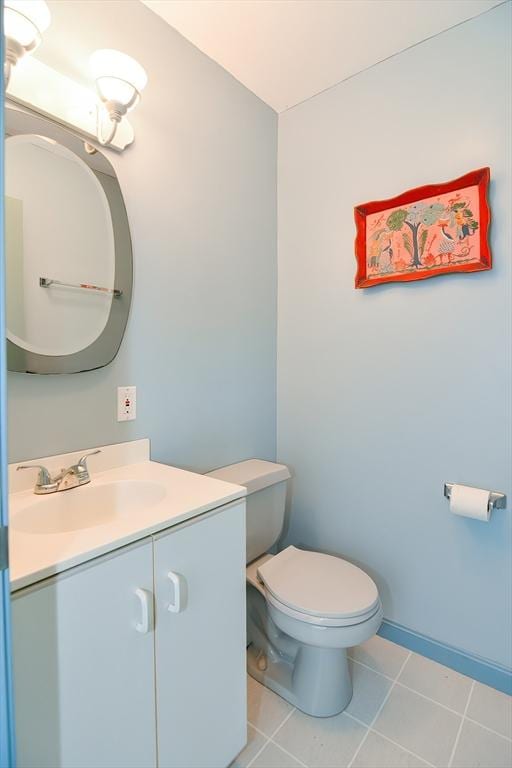 bathroom featuring tile patterned flooring, vanity, and toilet