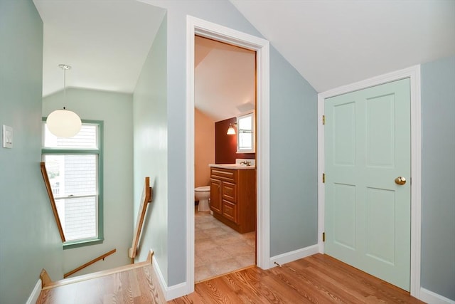 bathroom with toilet, lofted ceiling, hardwood / wood-style floors, and vanity