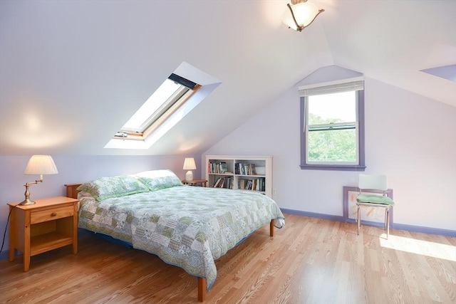 bedroom featuring vaulted ceiling and light hardwood / wood-style floors