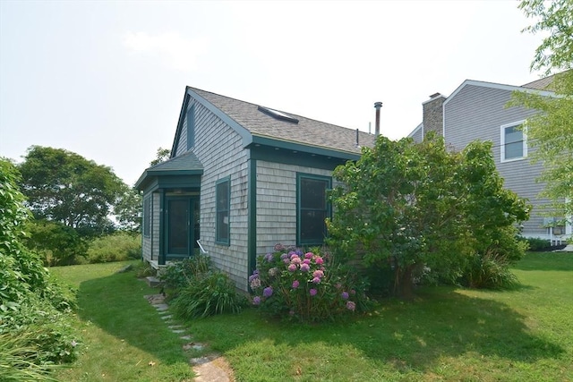 view of property exterior with a yard