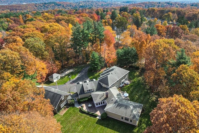 birds eye view of property with a forest view