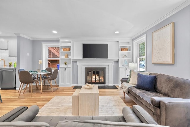 17 Henley St Unit B, Boston, MA 02129 - living area with crown molding, light wood-type flooring, recessed lighting, a brick fireplace, and built in shelves