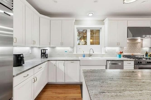 38 Paul Revere Rd, Lexington, MA 02421 - kitchen with high quality appliances, under cabinet range hood, a sink, and white cabinetry
