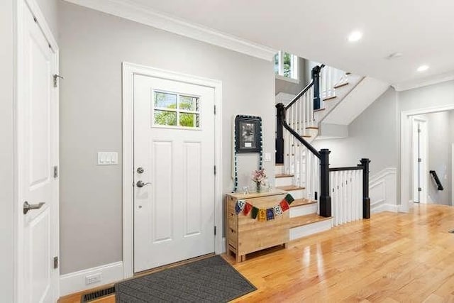 38 Paul Revere Rd, Lexington, MA 02421 - foyer entrance with ornamental molding, wood finished floors, stairs, recessed lighting, and baseboards
