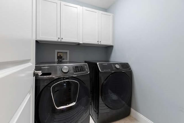 38 Paul Revere Rd, Lexington, MA 02421 - laundry area with cabinet space, washing machine and clothes dryer, and baseboards
