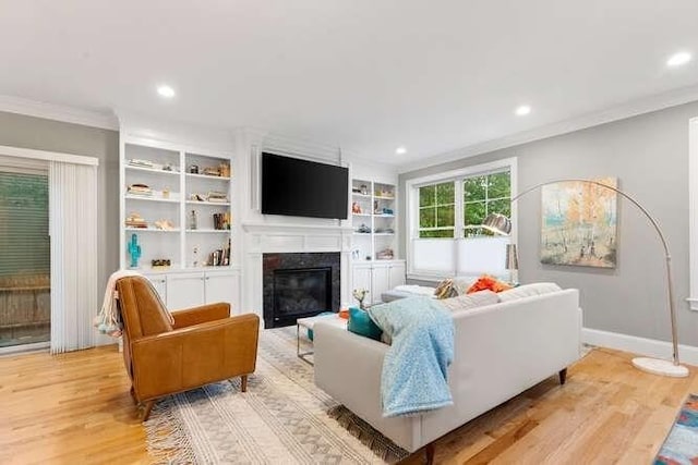 38 Paul Revere Rd, Lexington, MA 02421 - living room with ornamental molding, light wood-type flooring, recessed lighting, baseboards, and a glass covered fireplace