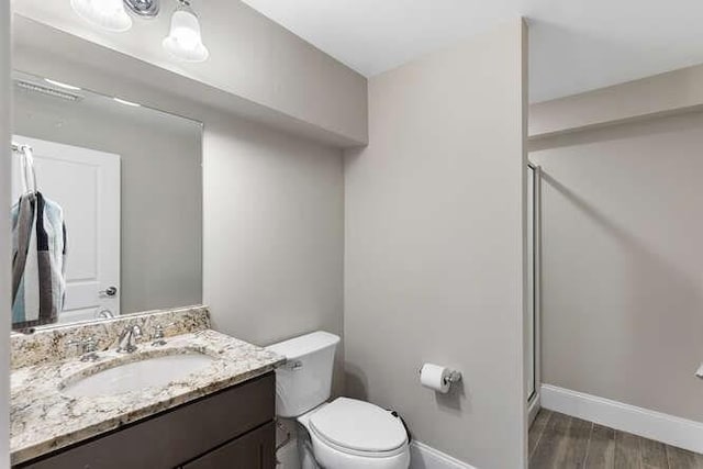 38 Paul Revere Rd, Lexington, MA 02421 - bathroom featuring vanity, toilet, a shower stall, wood finished floors, and baseboards