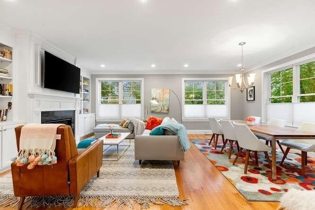38 Paul Revere Rd, Lexington, MA 02421 - living area featuring ornamental molding, light wood-type flooring, a fireplace, a chandelier, and recessed lighting