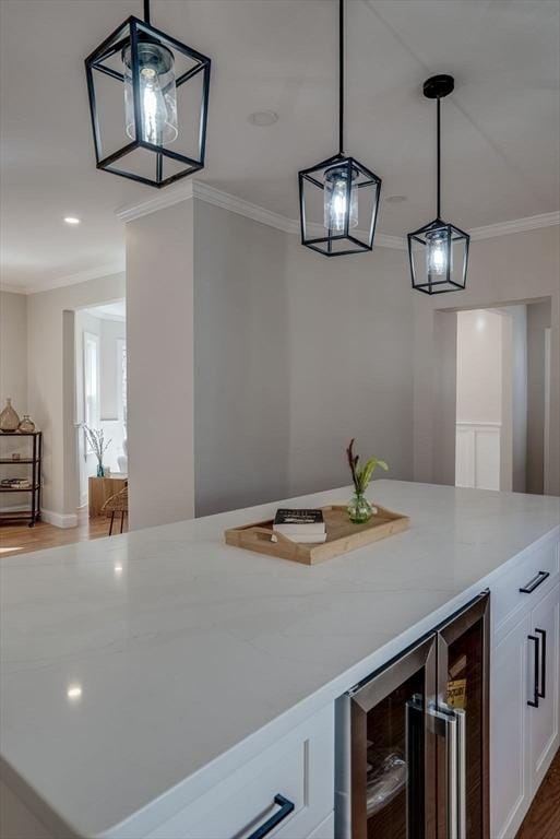 bar featuring ornamental molding, recessed lighting, wood finished floors, beverage cooler, and decorative light fixtures