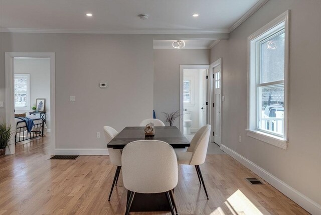 dining space with crown molding, light wood-style flooring, visible vents, recessed lighting, and baseboards