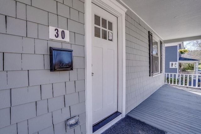 view of exterior entry with covered porch
